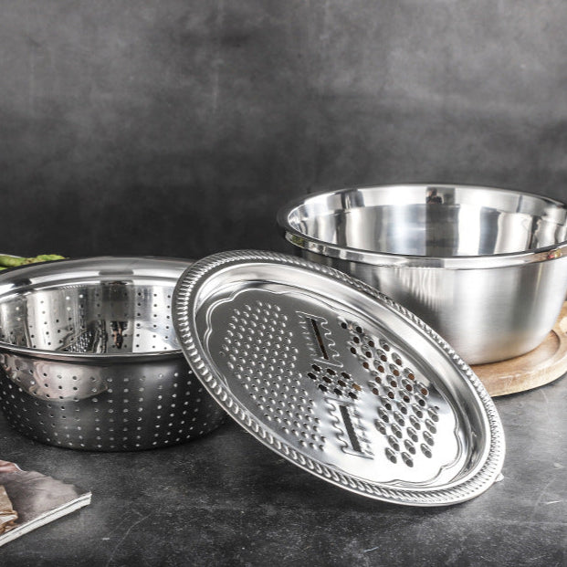 Stainless steel multi-functional Grating Basin and bowl set on a dark surface with a blurred background