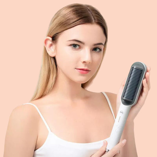 Woman holding a hair straightening brush against a pink background